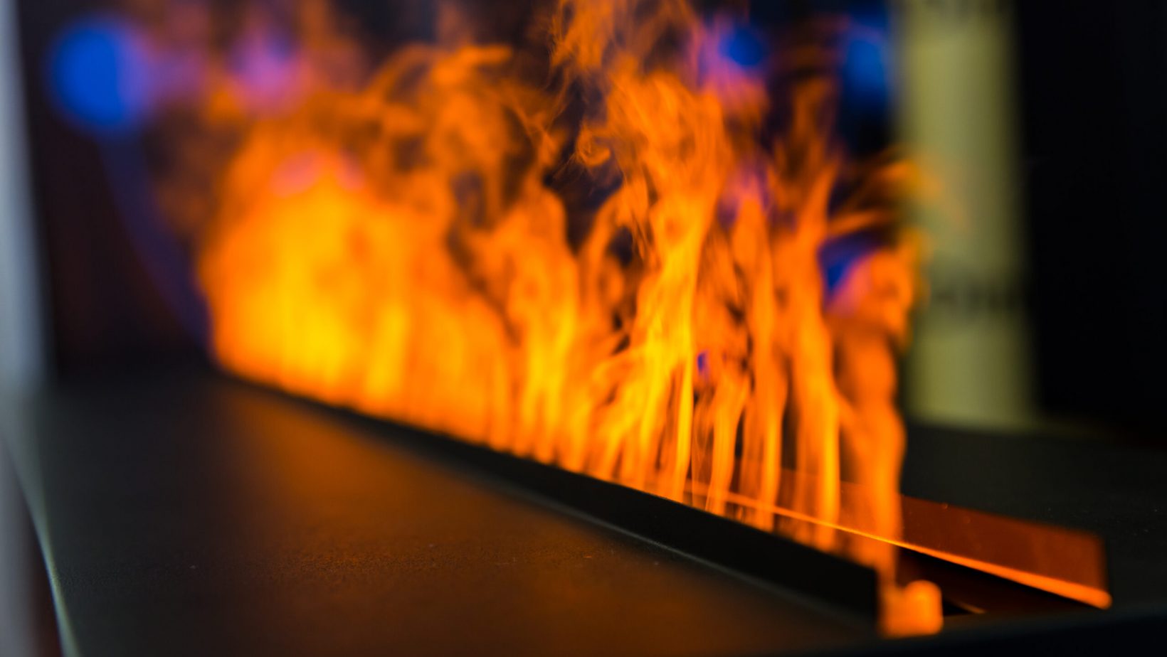 Flame line from gas fireplace, closeup. Fire, romantic interior decoration